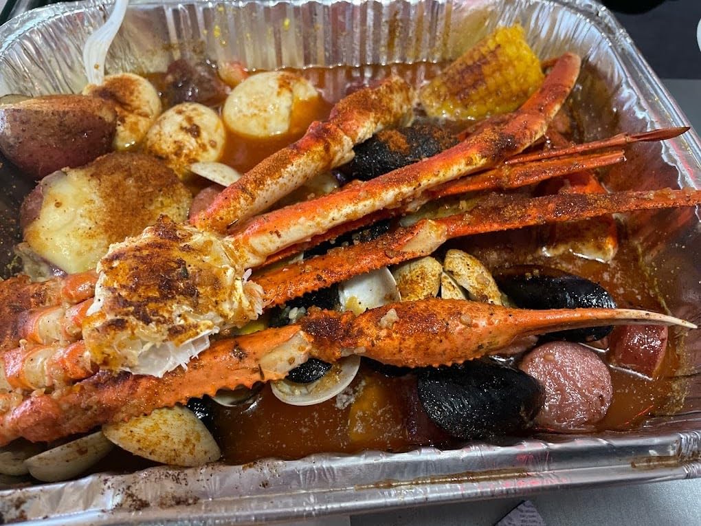 Seafood boil tray with crab legs, shrimp, corn and potatoes