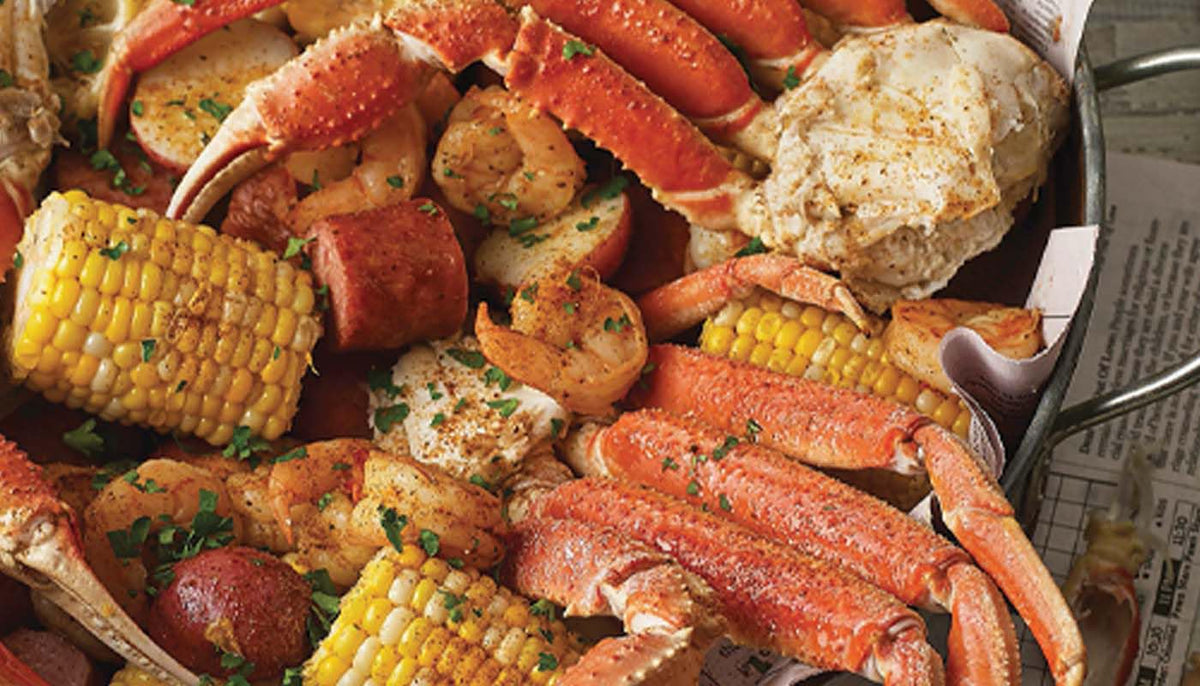 Crab legs, corn and potatoes coated with seafood boil sauce
